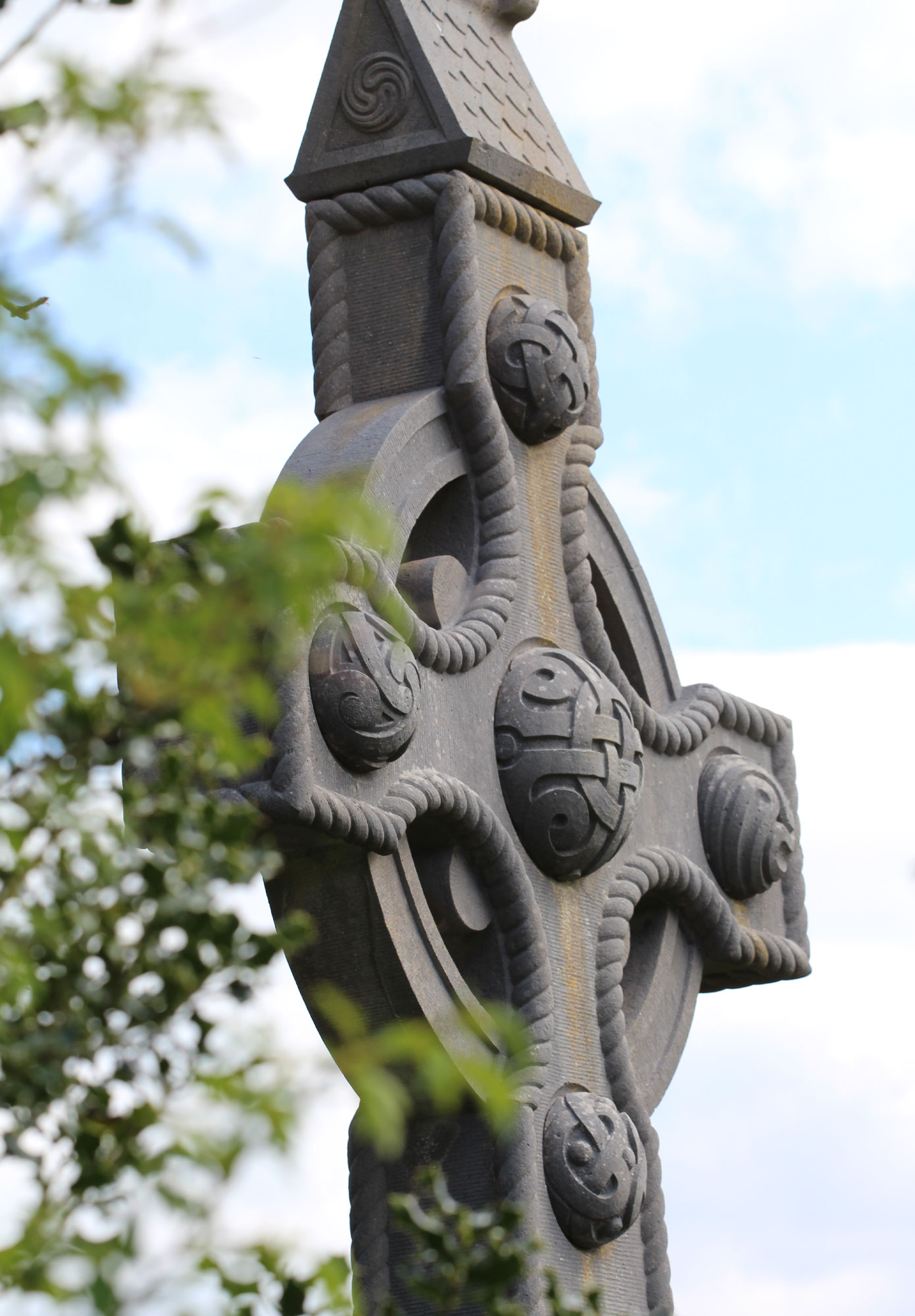 Decorated Celtic cross monument against the sky