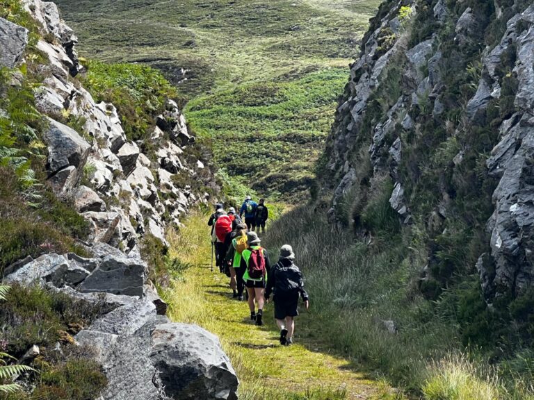 walkers goig trough an old railway cutting between Falcarragh and Creeslough, County Donegal, Ireland.