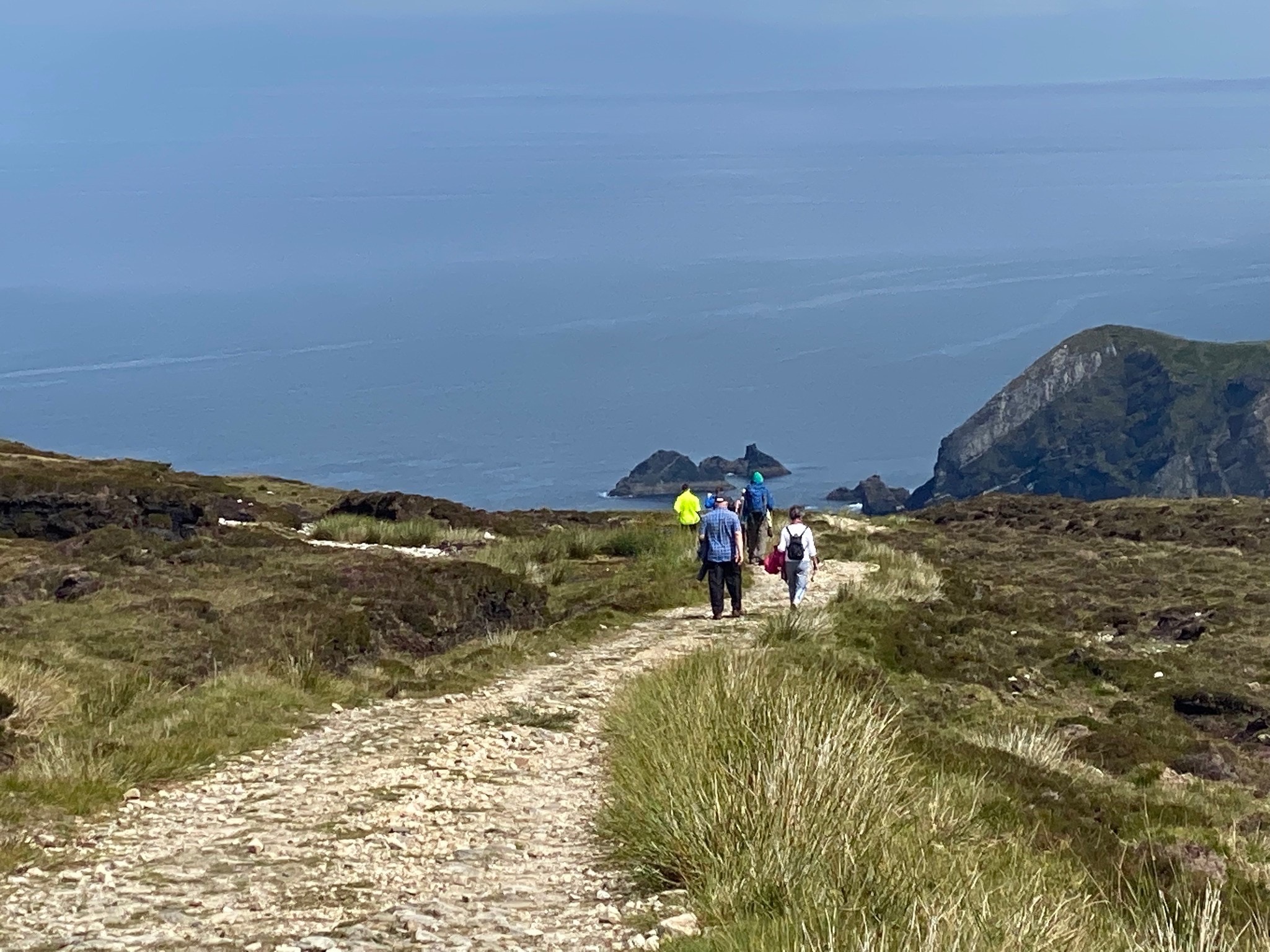 Walkers on the path from Glencolmbcille to An Port, County Donegal, Ireland.